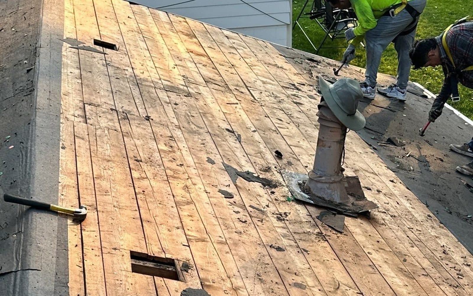 Innovative Roofing crew working on a residential roof during maintenance