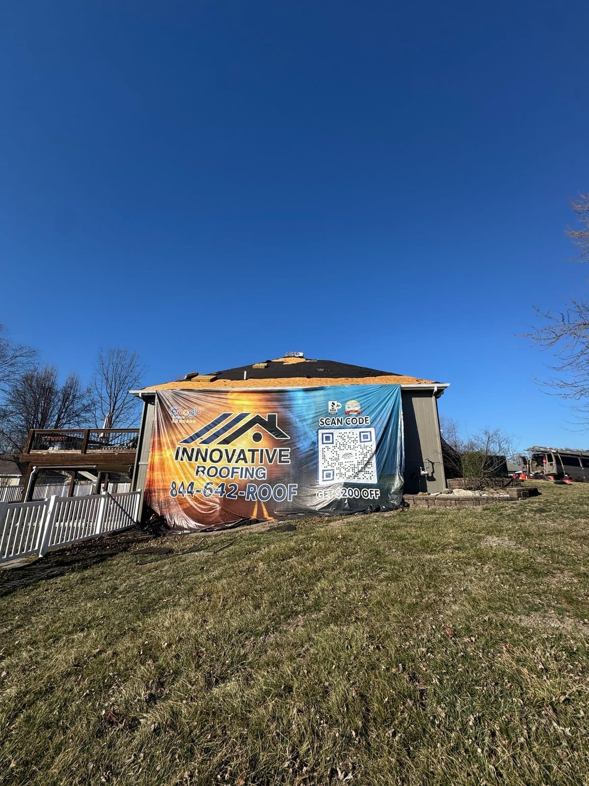 Innovative Roofing job-site banner on an active roof project