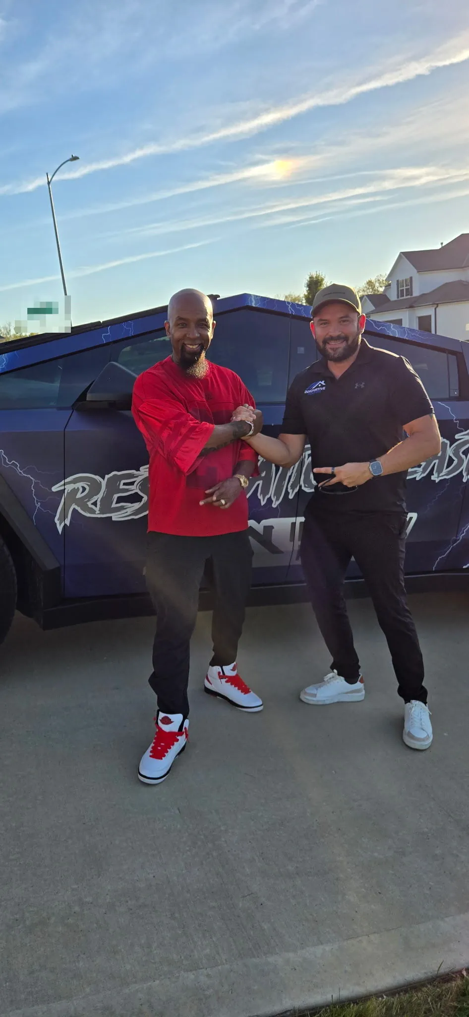 Tech N9ne with Ramiro Ortega, CEO of Innovative Roofing, by the Innovative Roofing Cybertruck in Kansas City