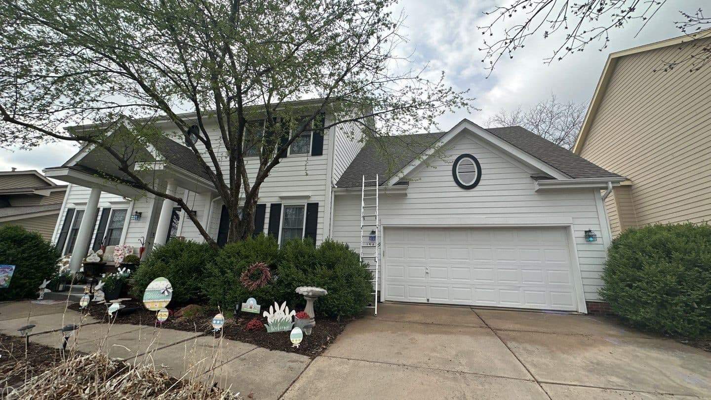 Finished multi-gable shingle roof on a two-story home with an attached garage