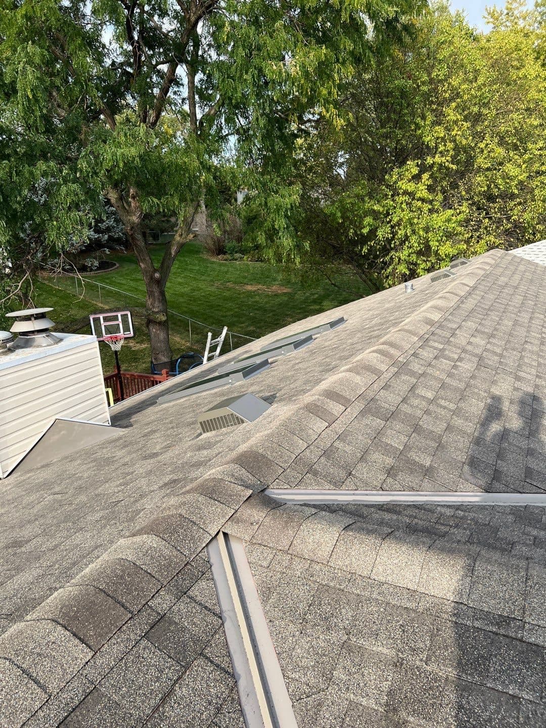 Close-up of a finished shingle valley where two roof planes meet