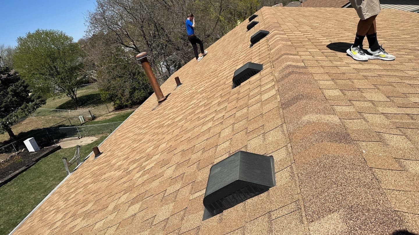 Innovative Roofing crew finishing a newly shingled roof with new roof vents