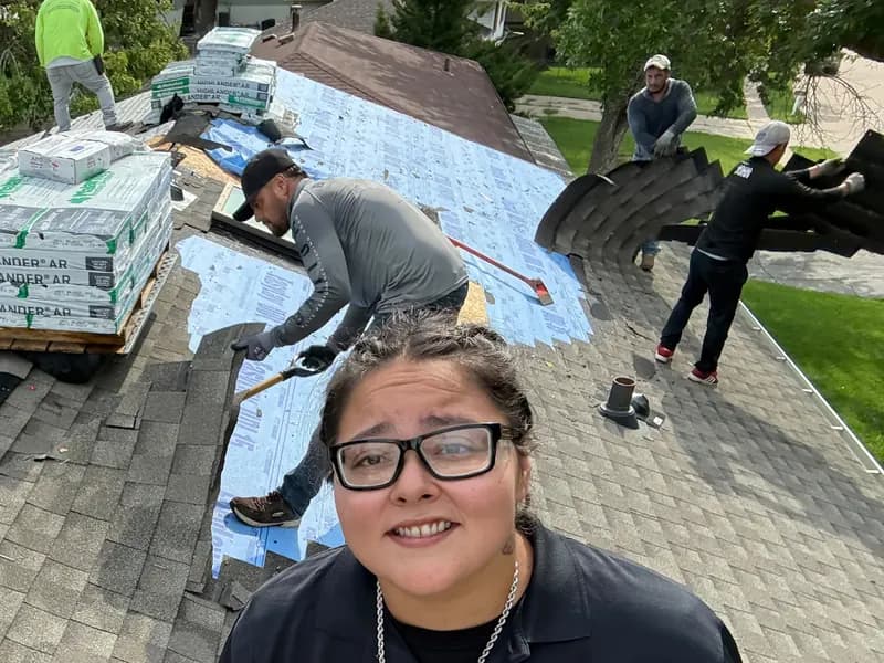 Innovative Roofing crew installing underlayment and stripping old shingles on a Kansas City area roof