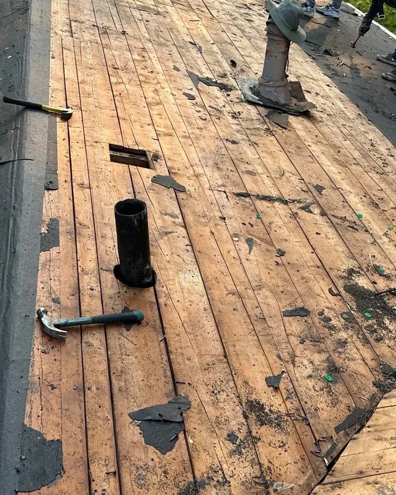 Omaha-area roof torn off down to the wood decking, with the crew working near the ridge