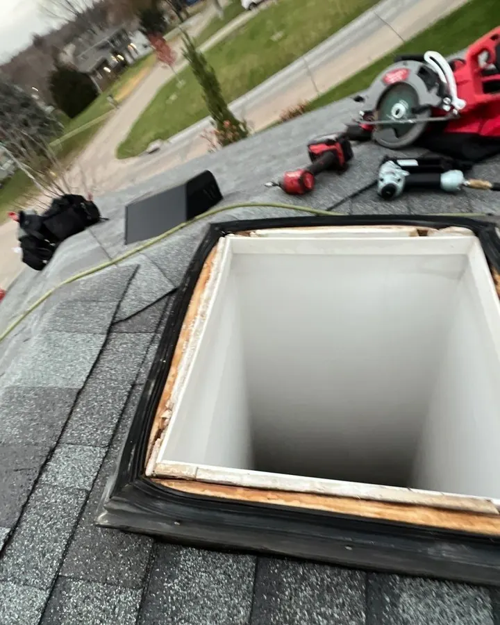 Open skylight curb with tools nearby during roof work on an Omaha-area home