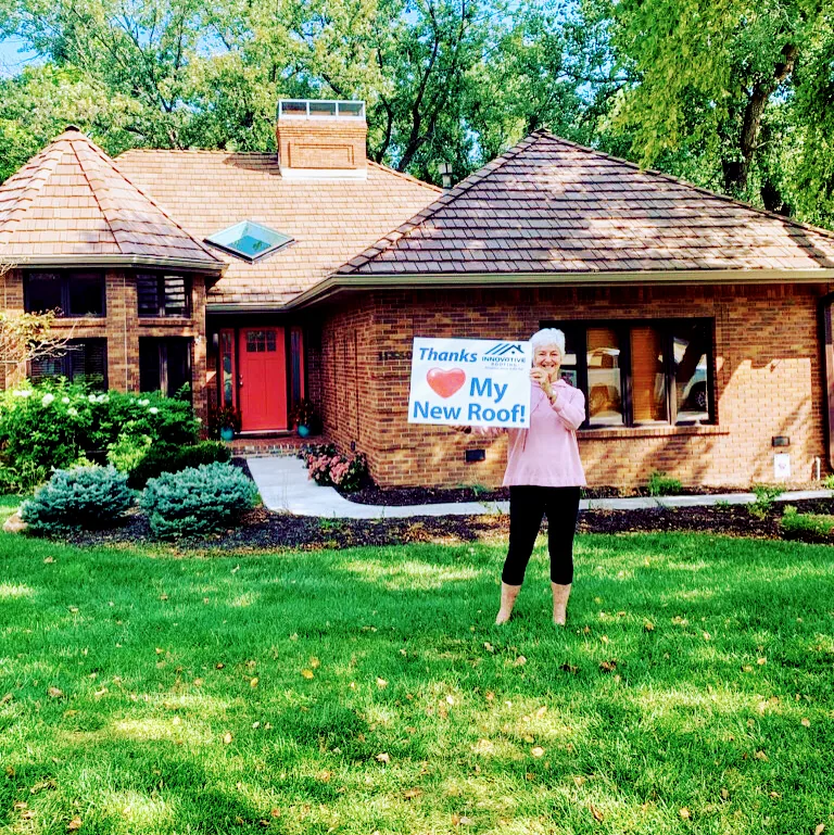 Omaha homeowner celebrating her new roof