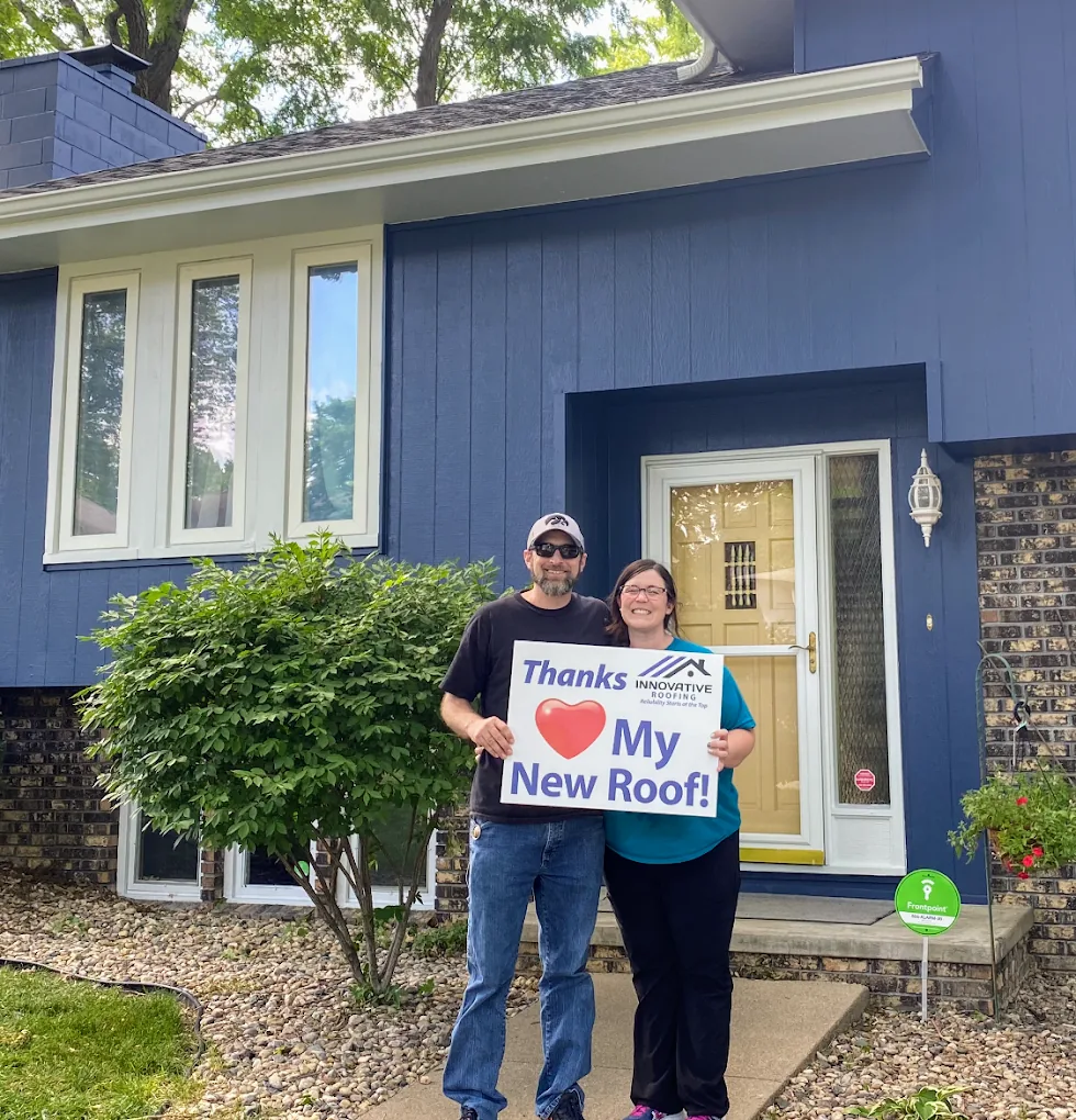Omaha couple holding a Thanks, I love my new roof sign