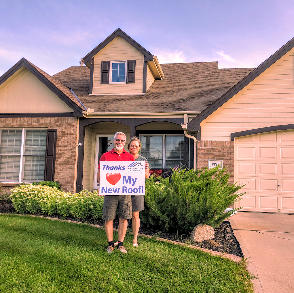 Omaha homeowner celebrating a completed roof replacement
