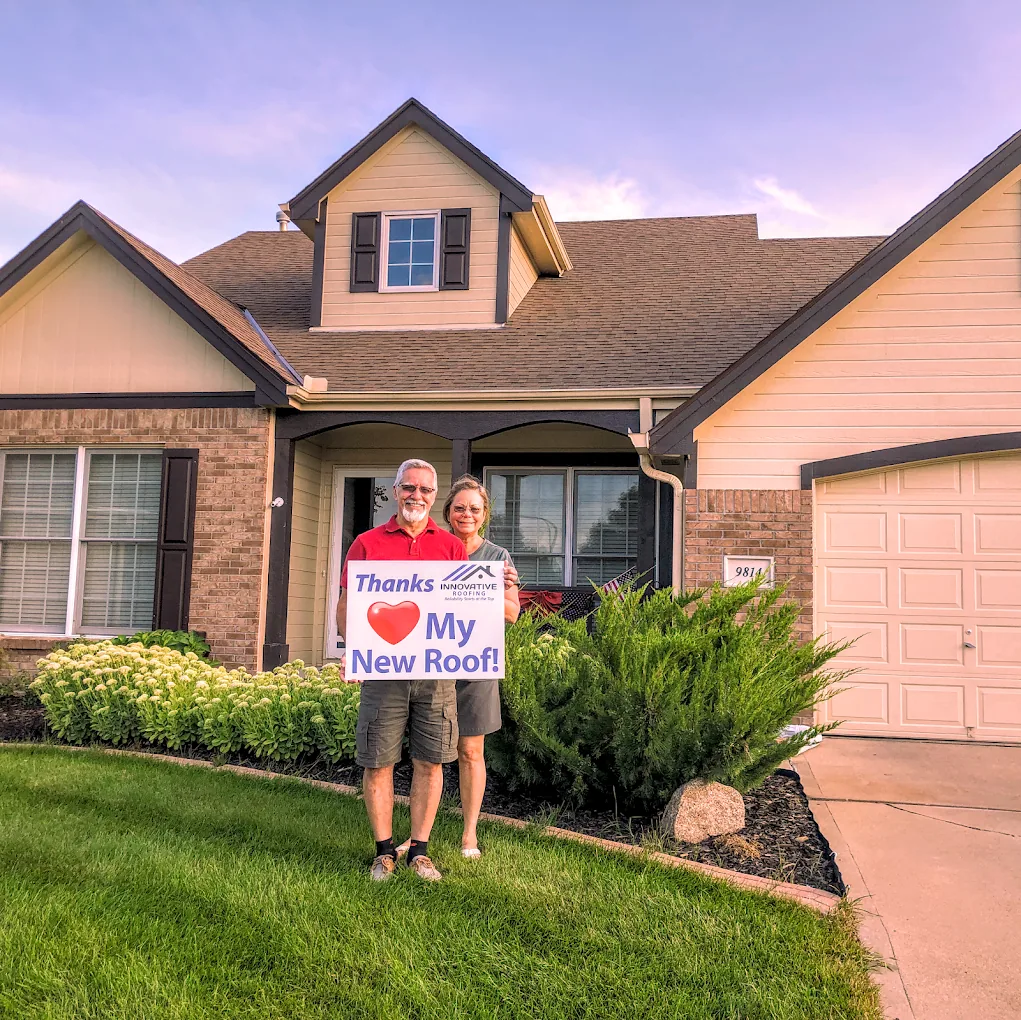Omaha homeowner celebrating a completed roof replacement
