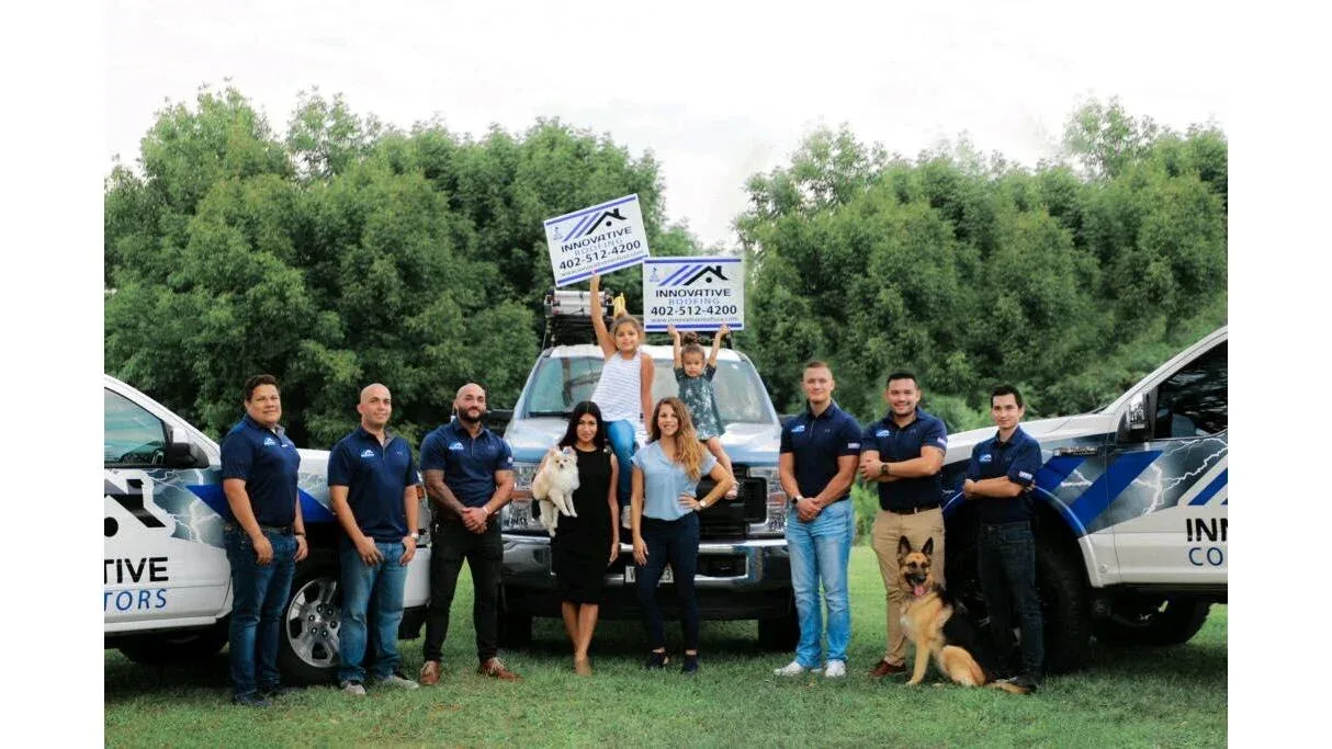 Innovative Roofing Omaha team with company vehicles